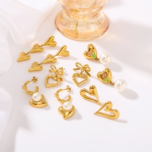 Set of five gold titanium steel heart earrings with pearls and bowknot tassels