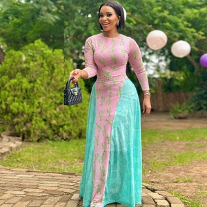 Colorful long-sleeved dress with pink-blue patchwork and lobster print in outdoor setting
