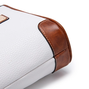 Close-up of white and brown pebbled leather texture with fine contrast stitching