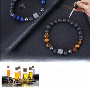 Detail showing essential oil absorption on 8mm tiger eye and lava stone diffuser bracelet