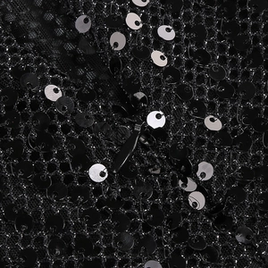Detail shot of the sequin embroidery fabric and invisible zipper on the black evening dress