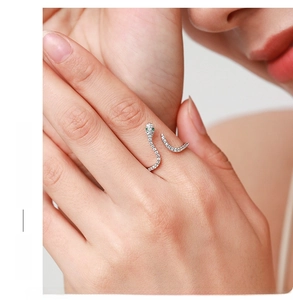 Close-up of S925 sterling silver snake ring with green stone eyes and clear zircon inlay