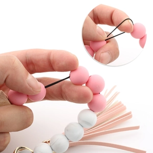 Elastic silicone bead keychain bracelet with pink tassel and stretchable wristband cord