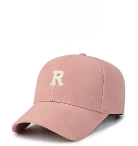 Close-up of pink cotton baseball cap with white 3D embroidered R letter on front