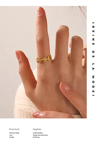 Close-up of 18K gold plated leaf ring with realistic vein textures on a model finger