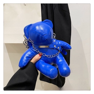Detail of blue PU leather bear bag with silver chain and rivet collar punk style