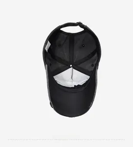 Detailed interior of black baseball cap with washing label and distressed brim edges