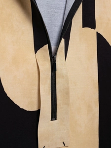 Detail of the high-quality zipper and stand collar on this patterned two-piece set
