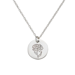 Macro view of silver carnation flower engraving on a polished mirror surface pendant