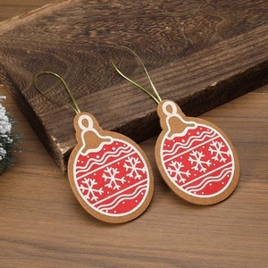 Detail of red Christmas felt ball ornaments with white snowflakes on rustic wood background