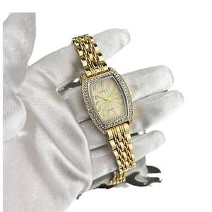 Elegant gold tonneau quartz watch with emerald dial and crystal bezel for women