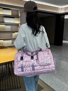 Large travel bag with purple leopard print, adjustable shoulder strap and hand carry straps