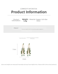 Détail de boucles d'oreilles pampilles dorées avec œil de chat et mesures de l'aiguille