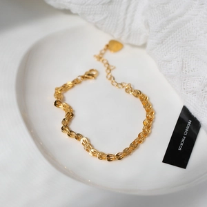 Gold titanium steel wheat chain bracelet featuring a delicate heart charm and lobster clasp