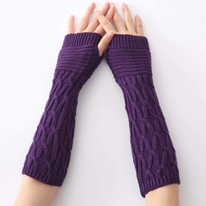 Detail of purple cable-knit fingerless gloves showing thick warm texture and arm sleeve length