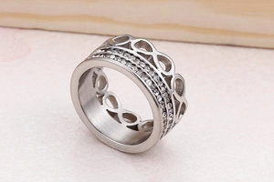 Macro detail of silver infinity symbol ring with triple rows of pavé diamonds