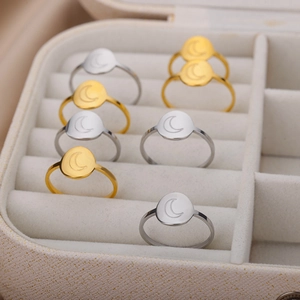 Minimalist 18K gold and silver stainless steel sun moon rings displayed in jewelry box