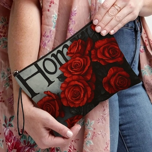 Dark rose print cosmetic bag with Home text held by a model in floral apparel