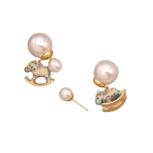 Polished gold rocking horse earrings with enamel details and large round white pearls