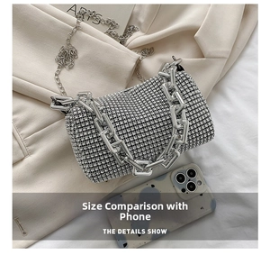 Detailed macro view of silver rhinestone handbag with thick chain and slim strap