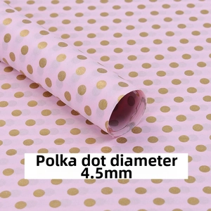 Detailed view of pink tissue paper featuring 4.5mm gold foil polka dots for wrapping