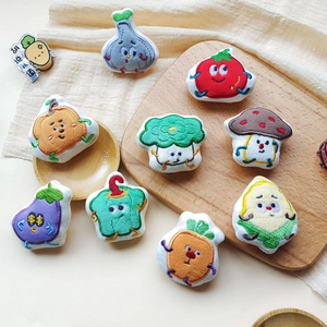Collection of various cartoon plush vegetable brooches with detailed embroidery work