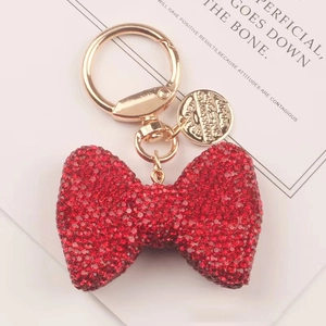 Portachiavi con fiocco di strass rossi e anello in oro per borse e accessori