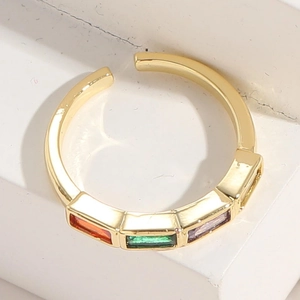 Detail of 14K gold plated ring featuring sunset orange, emerald, and lilac gemstones