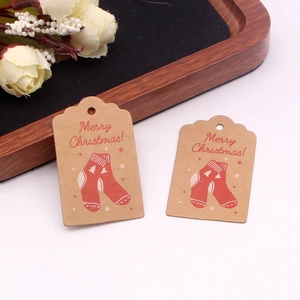 Detailed view of Kraft paper gift tags with Merry Christmas text and red stocking designs