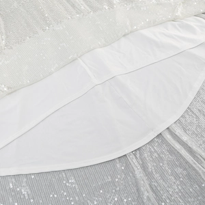 Detail of white sequin gown showing the inner lining and high-quality hem stitching