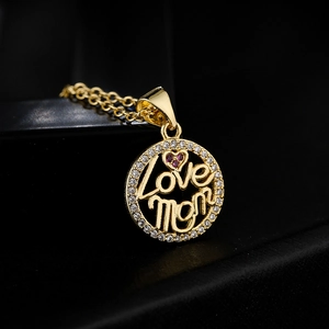 18K gold plated MOM heart pendant necklace with red and white zircons on dark background