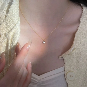 Minimalist 14K gold S925 sterling silver evil eye pendant necklace worn by a model