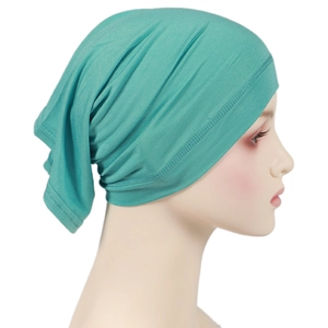 Detail of high-elasticity mint green modal hijab cap fabric on a female model head