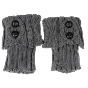 Close-up of gray knit leg warmers with diamond pattern and black decorative buttons