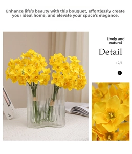 Detailed view of yellow silk narcissus petals and a transparent ribbed glass vase