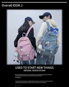 Lifestyle shot of trendy blue and pink large-capacity backpacks with badges for students