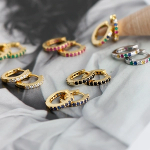 Macro detail of S925 sterling silver hoop earrings with multicolored cubic zirconia stones