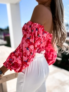 Detail of floral off-shoulder top with puff sleeves and elastic bodice design
