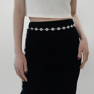 Close-up of silver metal waist chain with sparkling rhinestone circular link details