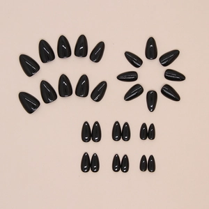 Glossy black short almond press-on nails set with 24 pieces on beige background