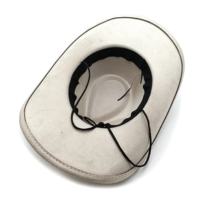 Detailed interior view of beige suede cowboy hat featuring adjustable black drawstring
