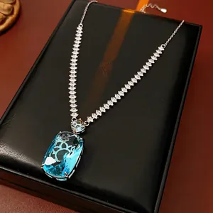 Elegant silver necklace with large rectangular blue zircon pendant on black leather box