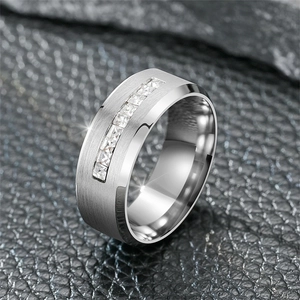 Close-up detail of a brushed titanium steel band featuring square-cut clear zircons