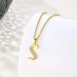 Macro shot of 18K gold plated S-letter pendant with sparkling zircon inlays on an O-chain