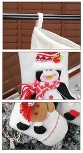 Detail of Christmas stocking hanging loop and 3D plush penguin and gingerbread man design