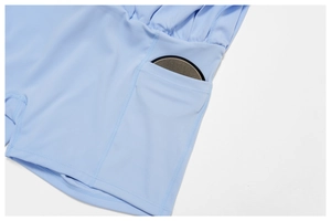 Macro detail of sky blue tennis skirt showing functional side pocket and soft fabric