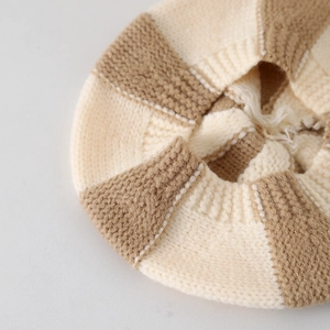 Fashionable two-tone knitted baby beret in beige and light brown with soft wool texture