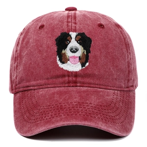 Close-up of Bernese Mountain Dog embroidery on a washed burgundy cotton baseball cap