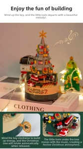 Close-up of a Christmas tree music box building blocks with rotating train base detail