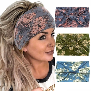 Detail view of wide floral yoga headbands with knot design in three color patterns